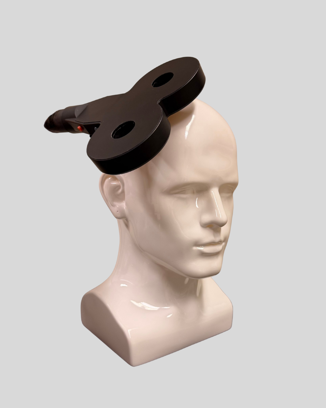 Image of a Transcranial Magnetic Current Stimulation Device connected to a model of a human head.